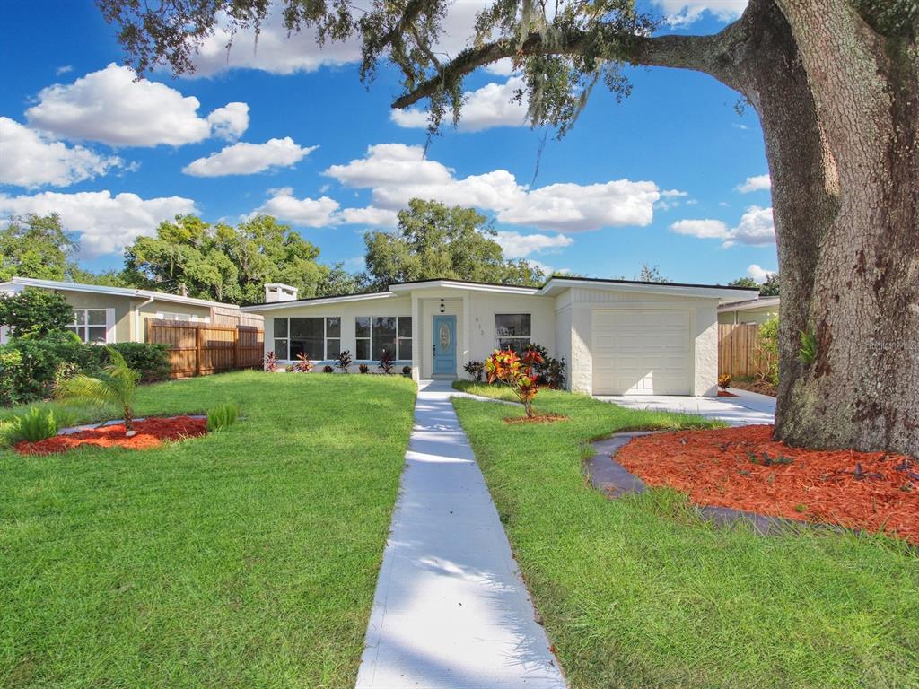 a front view of house with yard and green space