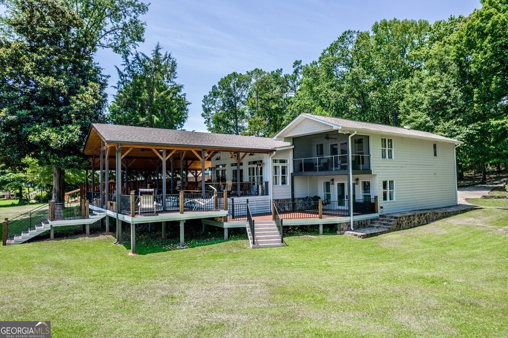 a view of a house with backyard porch and sitting area