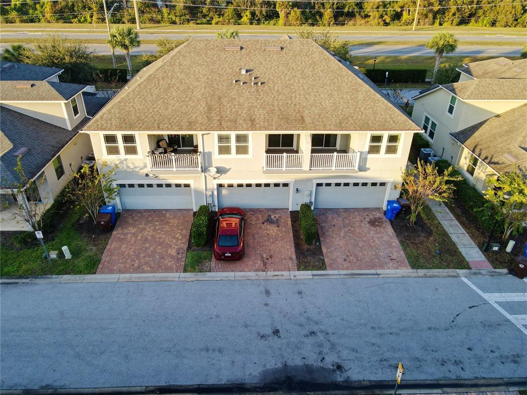 an aerial view of a house with a yard