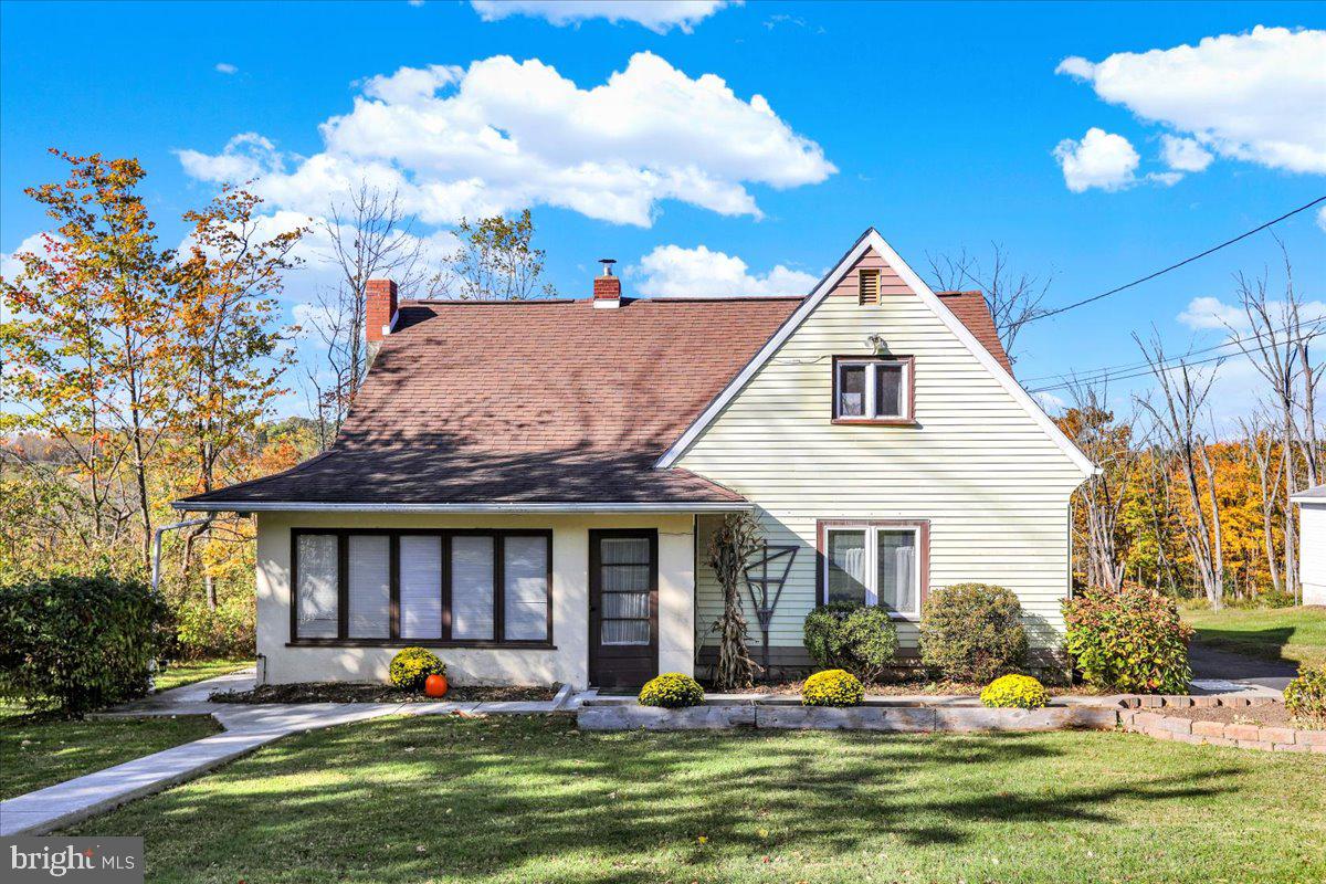 a front view of a house with swimming pool and porch