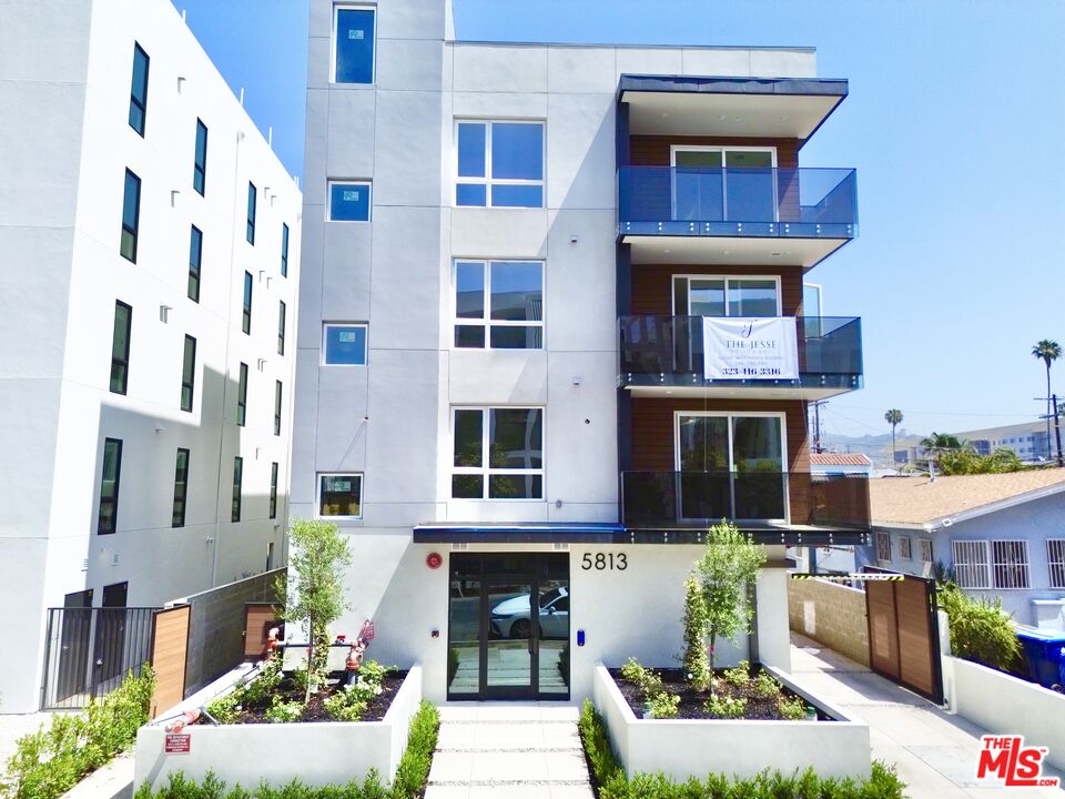 a front view of a building with outdoor seating