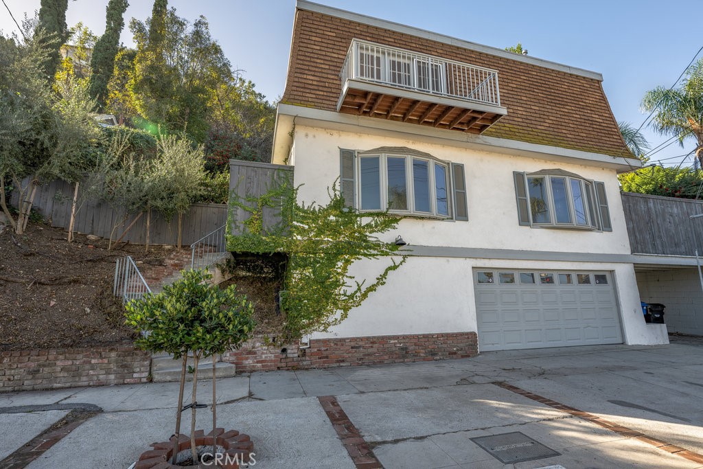 a front view of a house with a yard and a garage