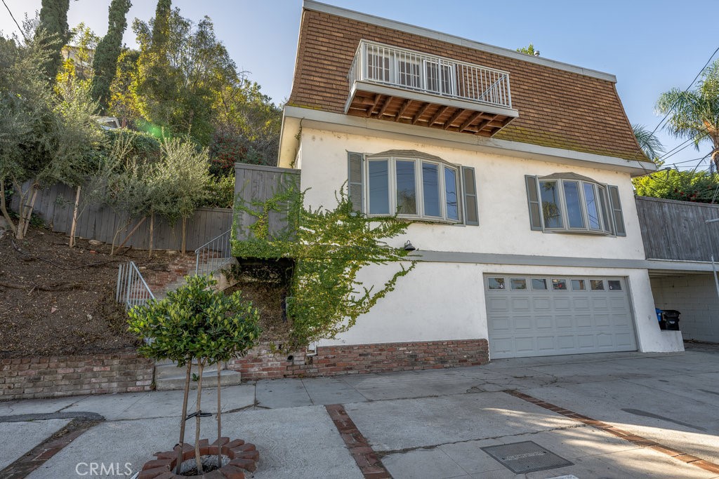 a front view of a house with a yard and a garage