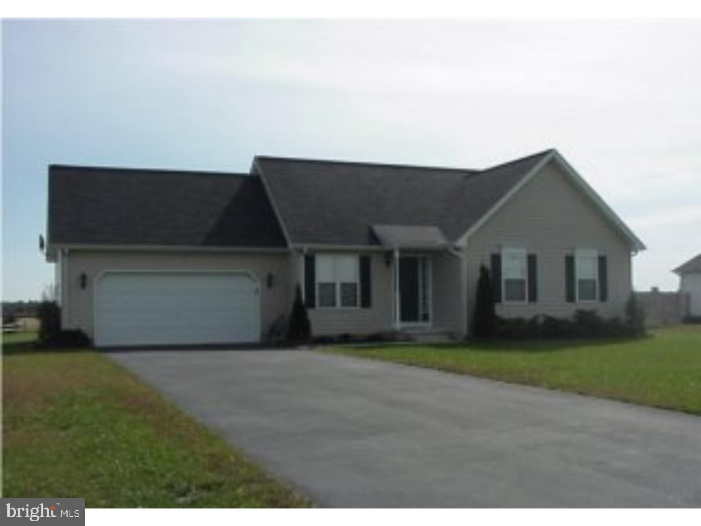 a front view of a house with a garden and yard