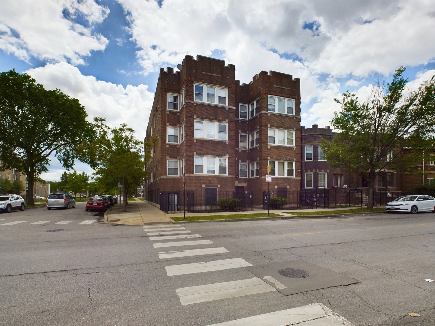 a view of a brick building next to a road