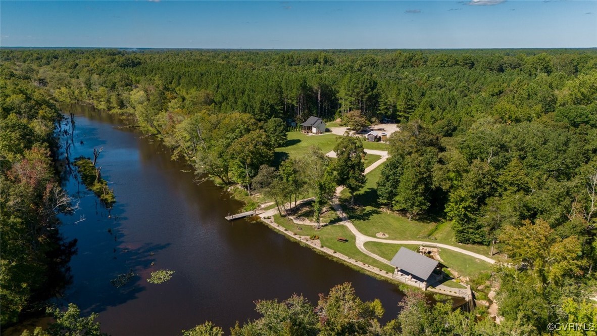 an aerial view of residential houses with outdoor space and lake view