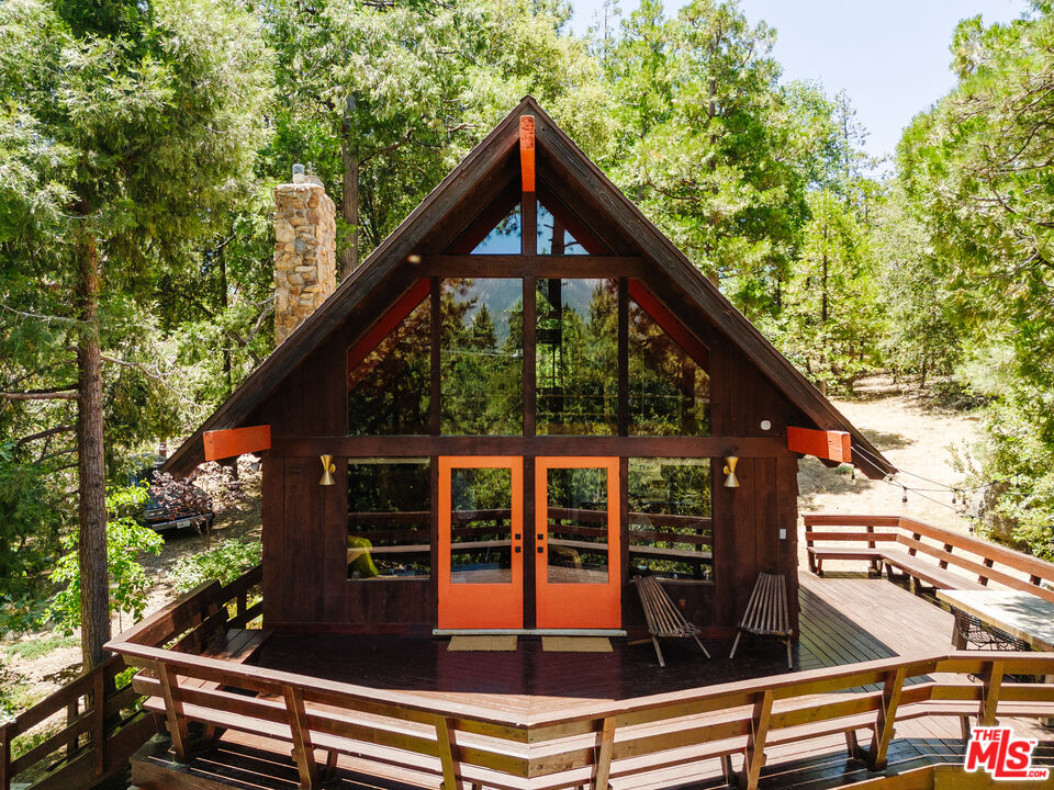 a view of backyard with deck and outdoor seating