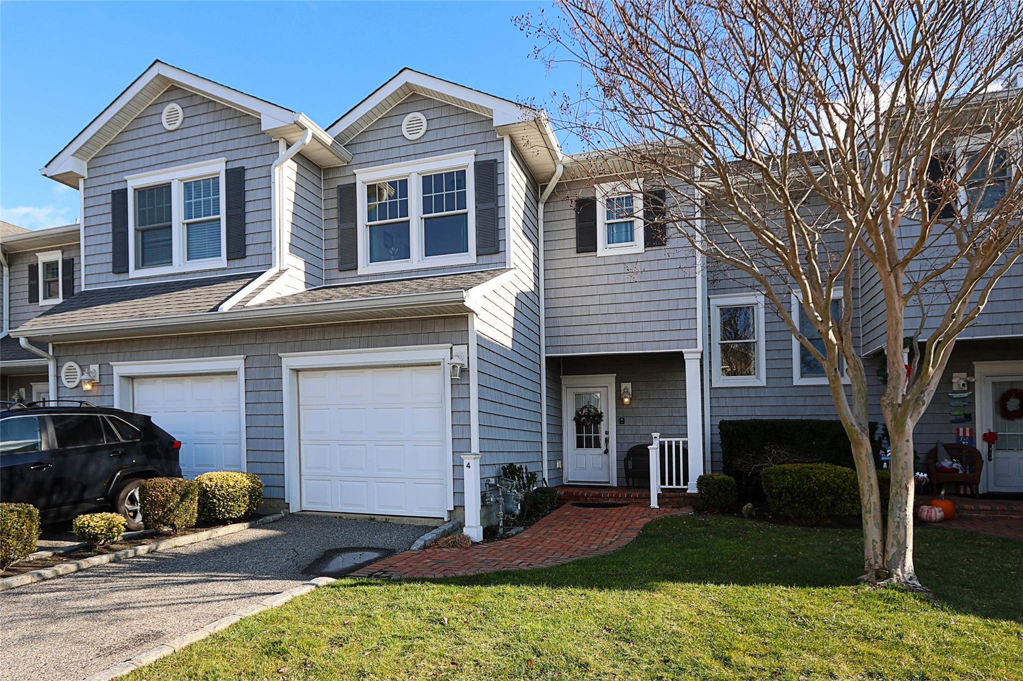 View of property with a garage and a front yard