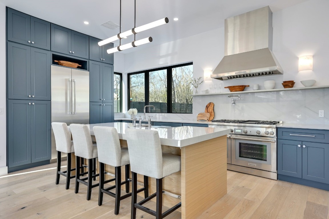 a kitchen with a table chairs stove and cabinets