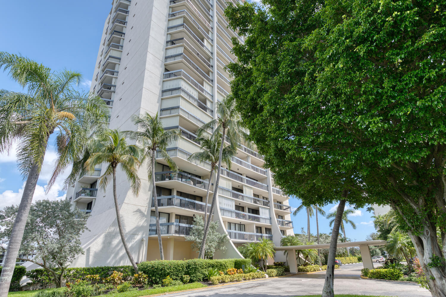 a view of a tall building next to a road