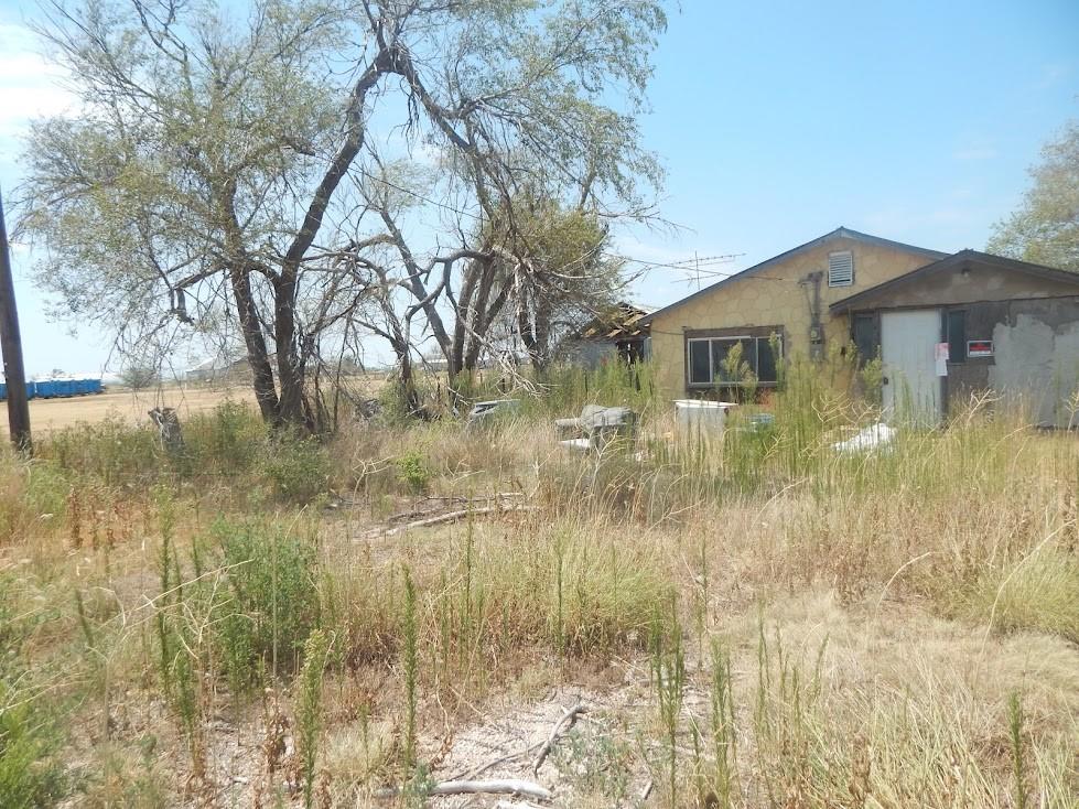 a view of a brick house next to a yard