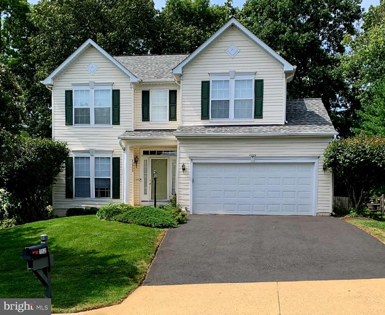 a view of a yard in front view of a house