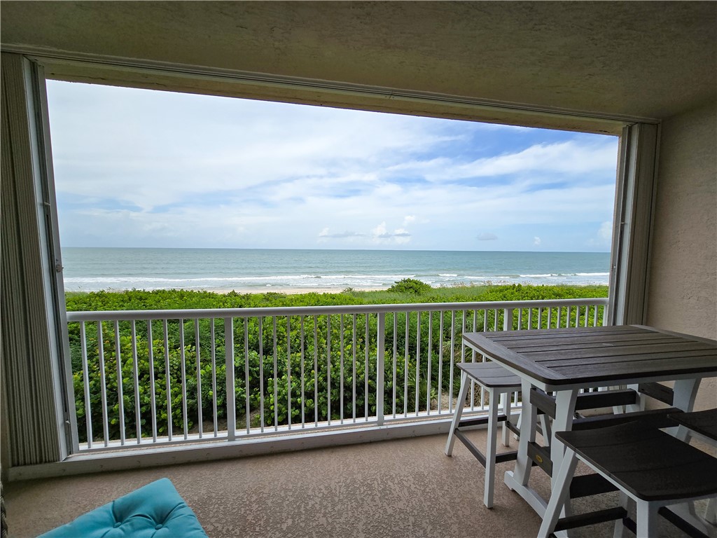 a view of a balcony with furniture