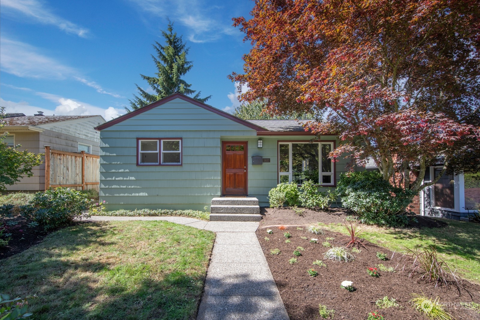 a front view of a house with a garden