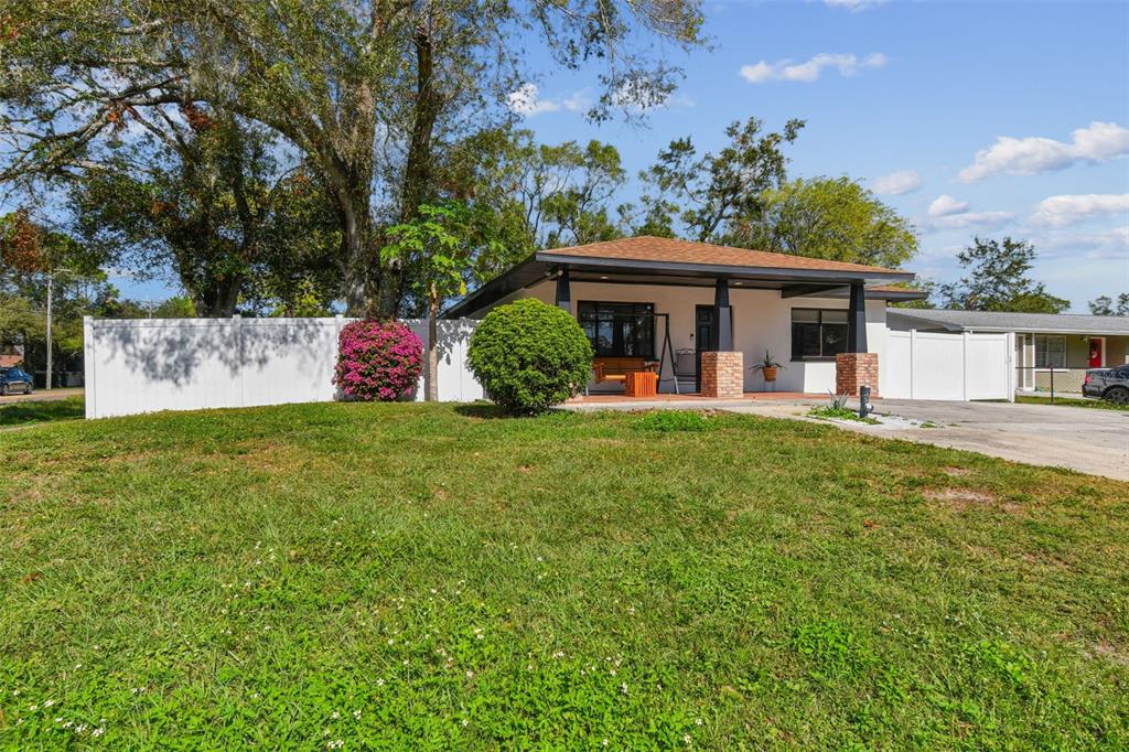 a view of a house with backyard sitting area and garden