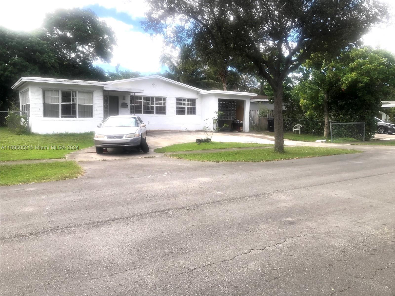 a front view of a house with a yard and porch