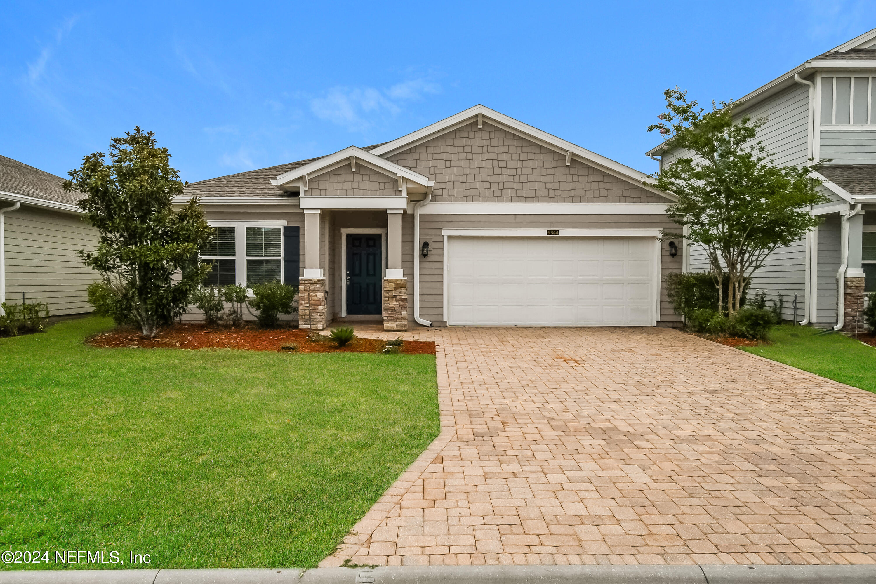 a front view of house with yard and green space