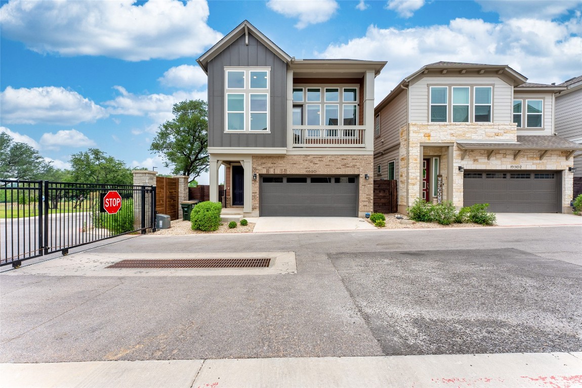 a front view of a house with a yard and a garage