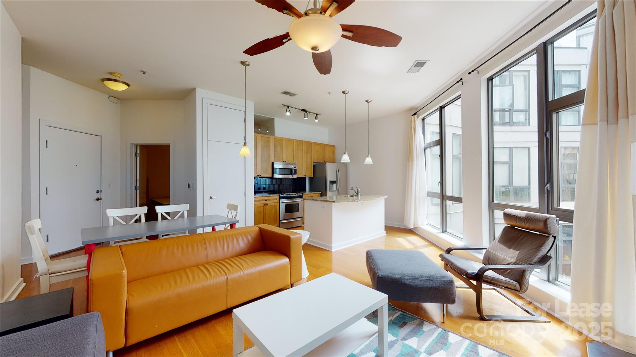 a living room with furniture and a large window