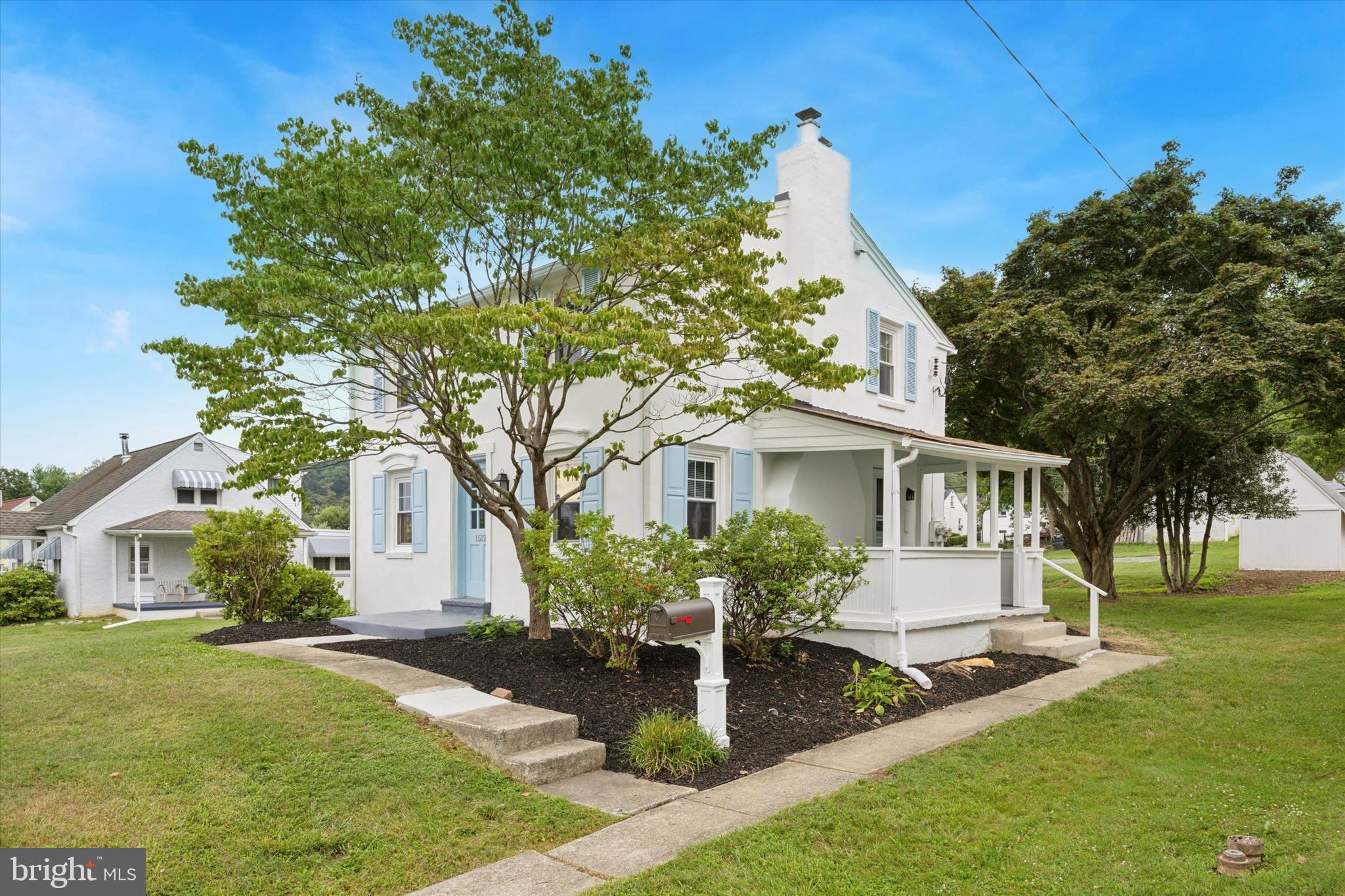 a front view of house with yard and green space