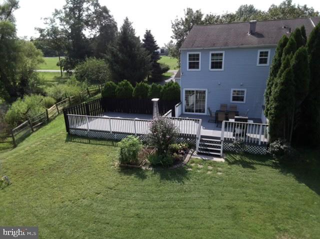 a view of a house with backyard sitting area and garden