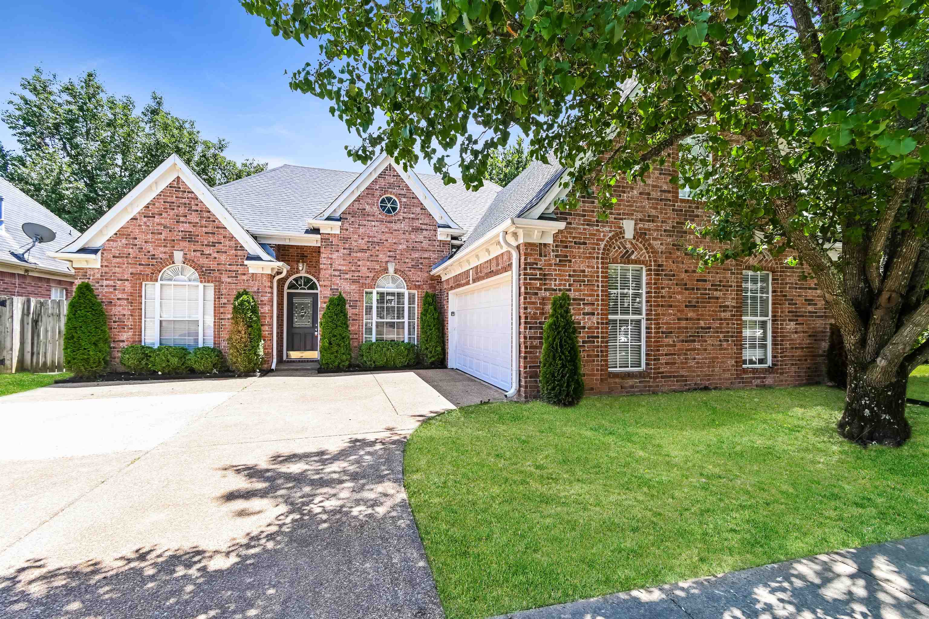 View of front of house with a front yard and a garage