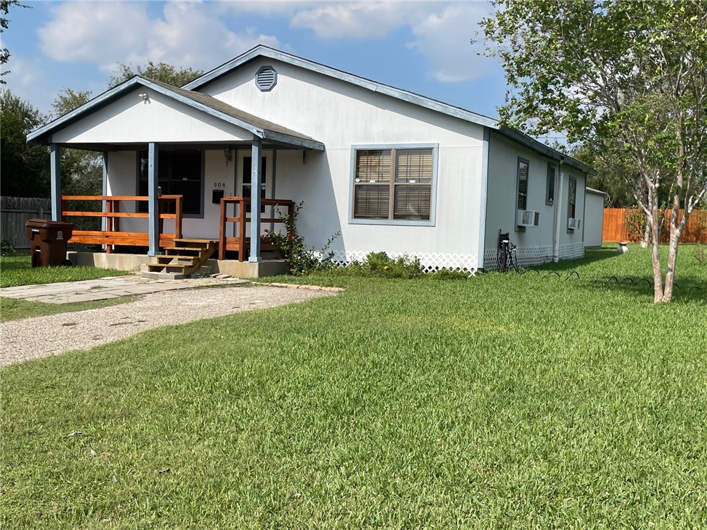 a view of a house with backyard porch and sitting area