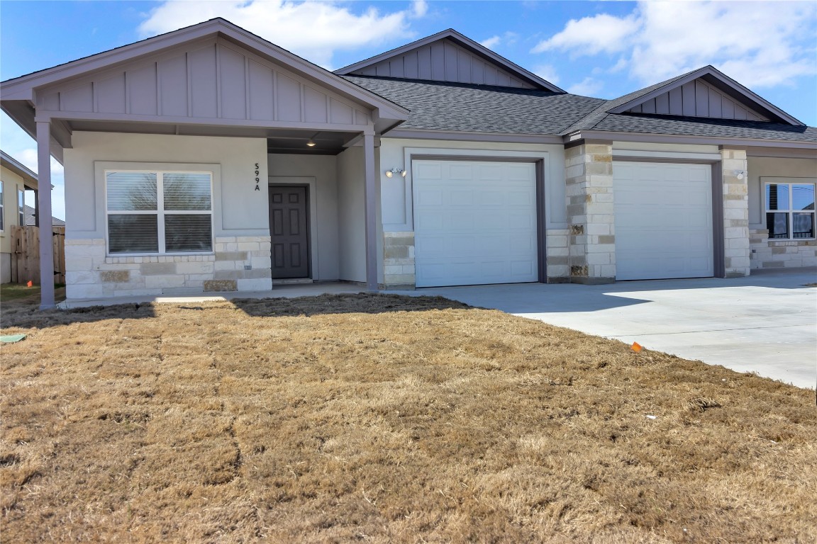 a view of house with yard outdoor space and glass windows