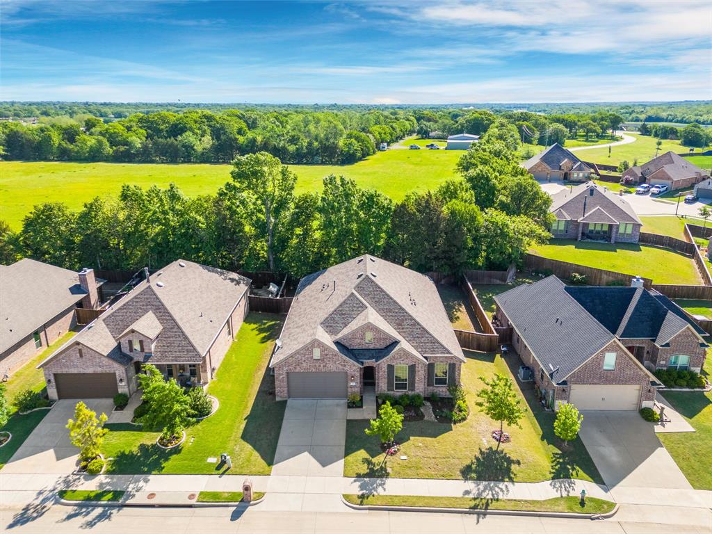 an aerial view of a house with a garden and lake view