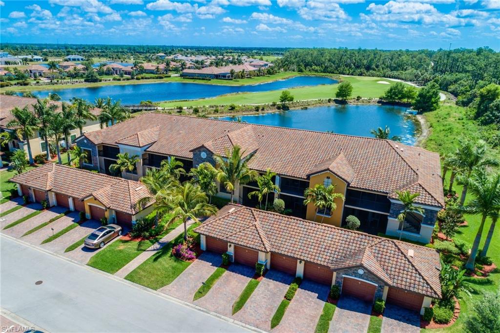 an aerial view of a house with a garden and lake view