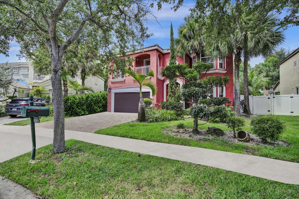 a view of a house with a yard and tree s