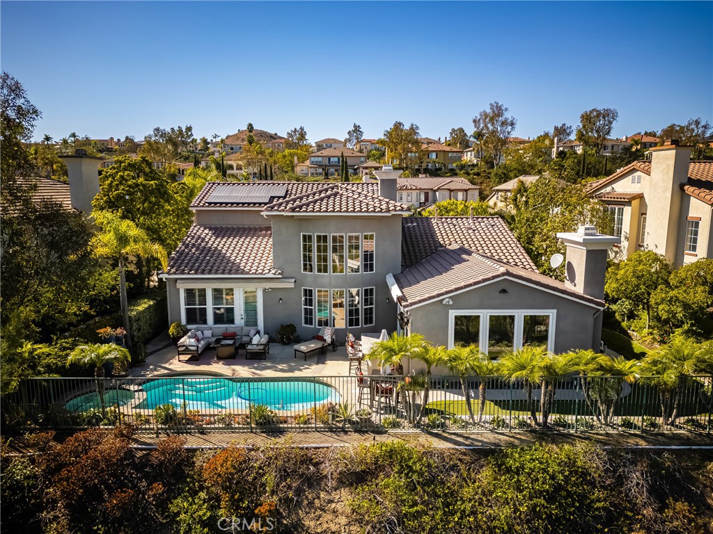 aerial view of a house with a yard and potted plants