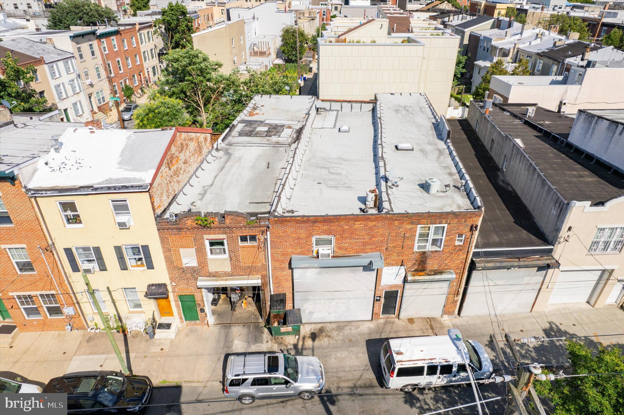 an aerial view of multiple houses with yard