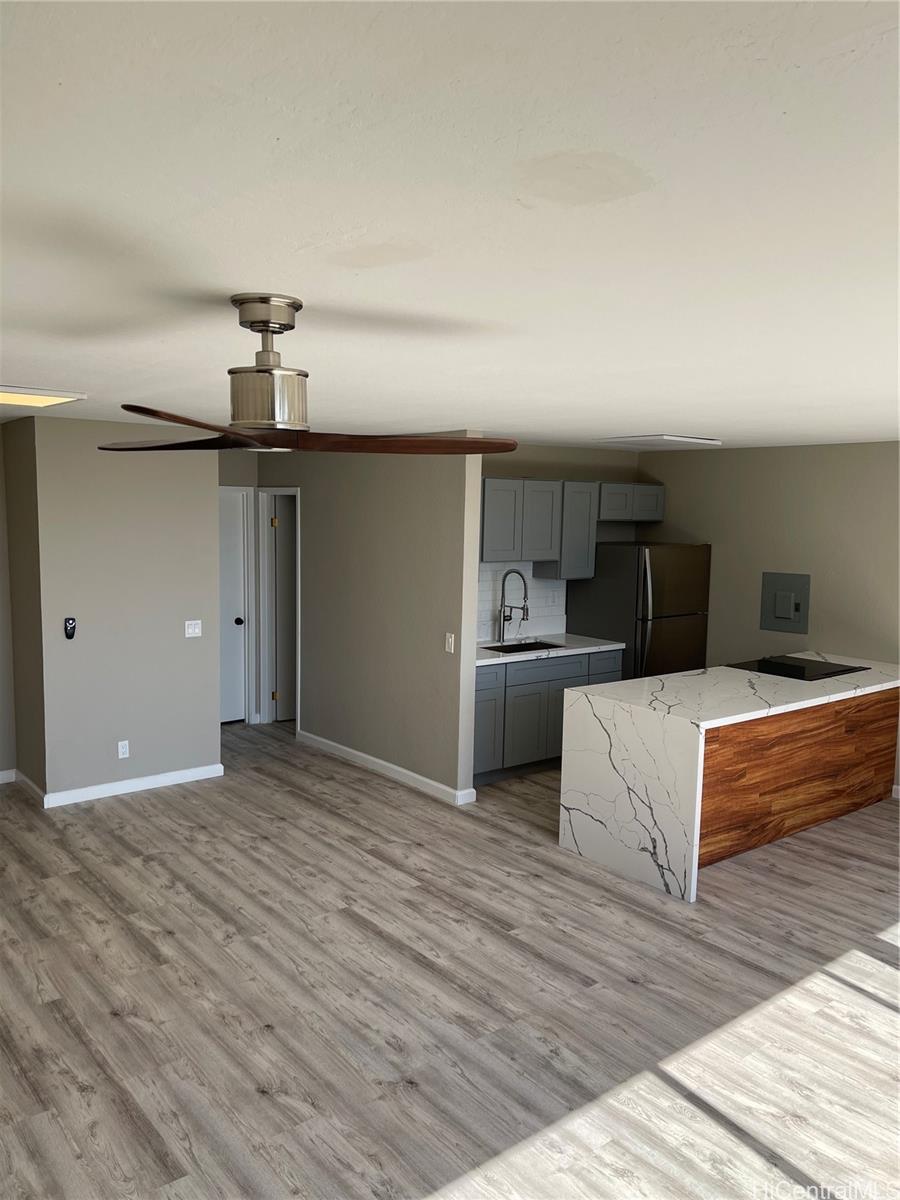 a view of a kitchen with a sink and wooden floor