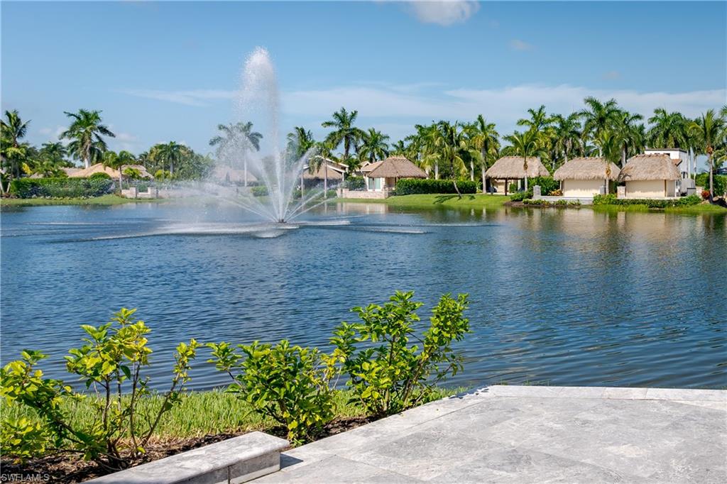 a view of a lake with a flower garden