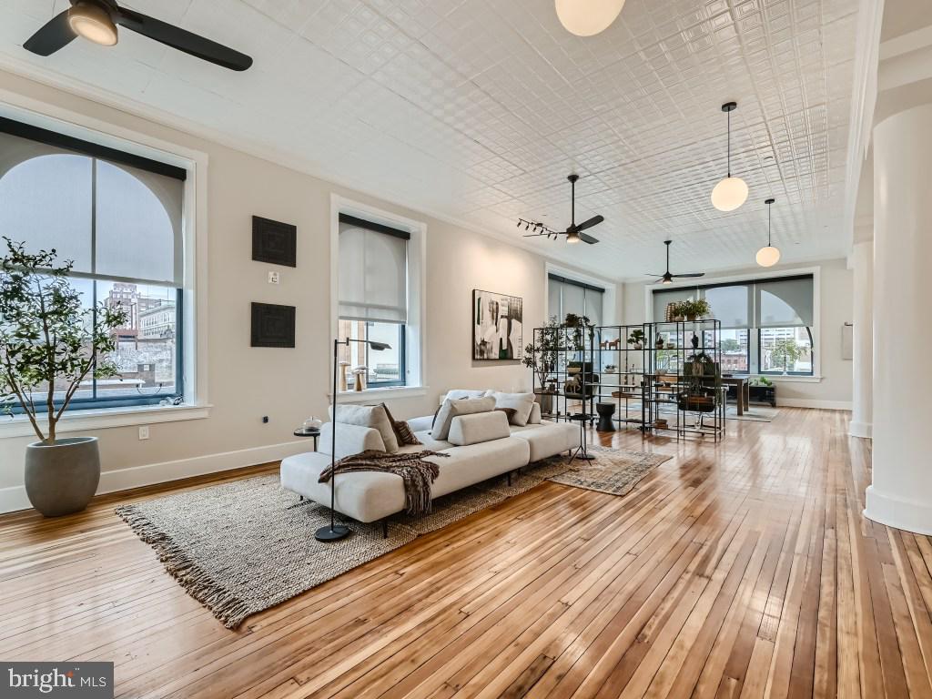 a living room with furniture and wooden floor