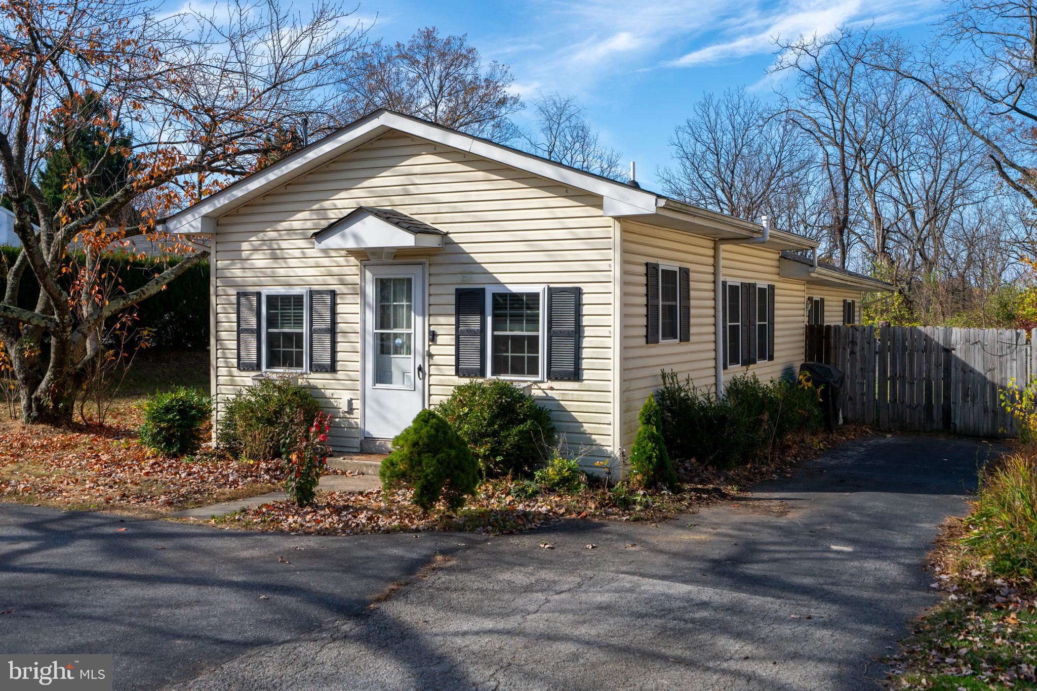 a front view of a house with yard and green space