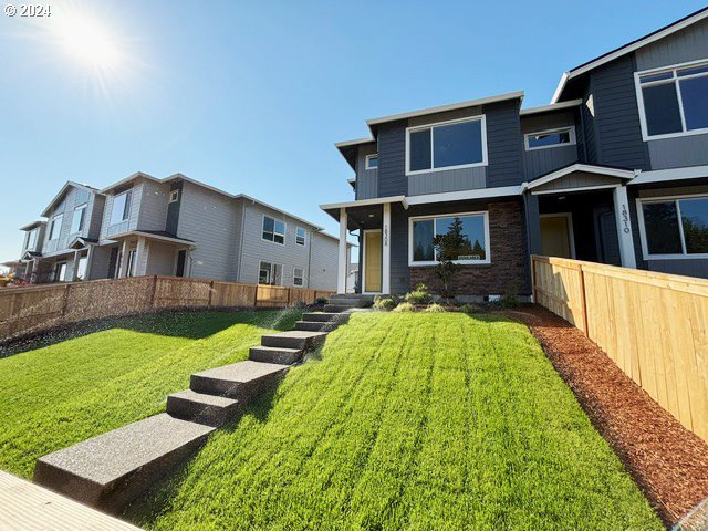 a view of house with yard