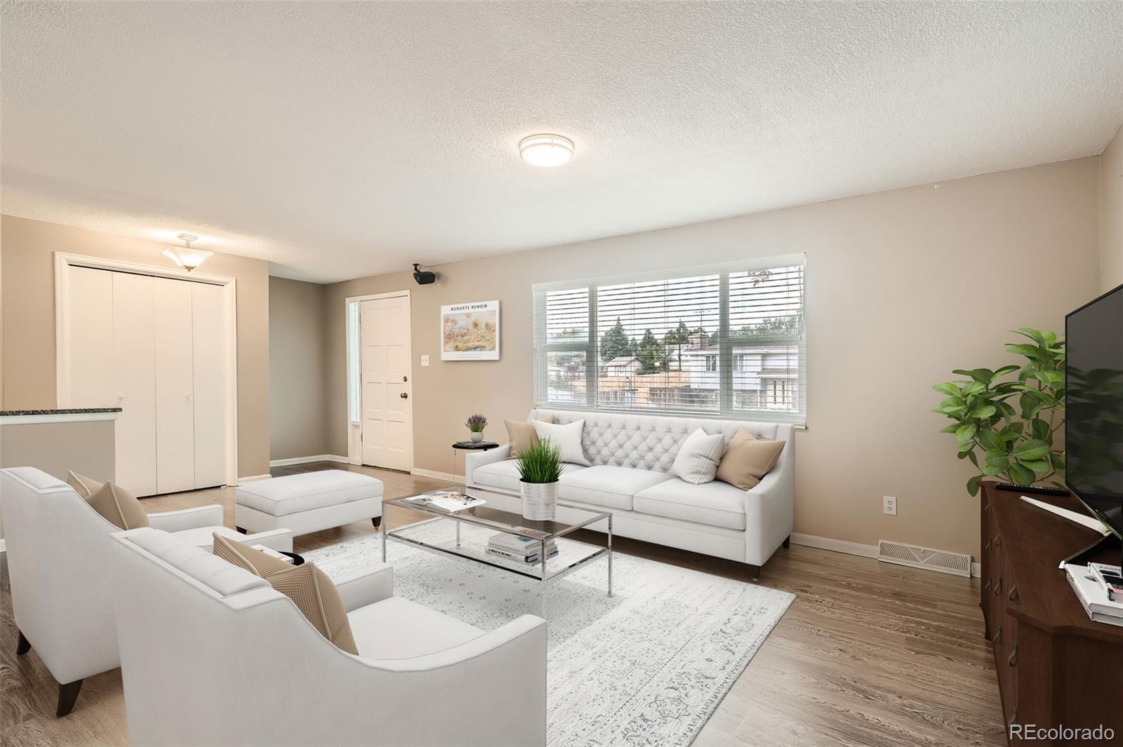 a living room with furniture and a potted plant