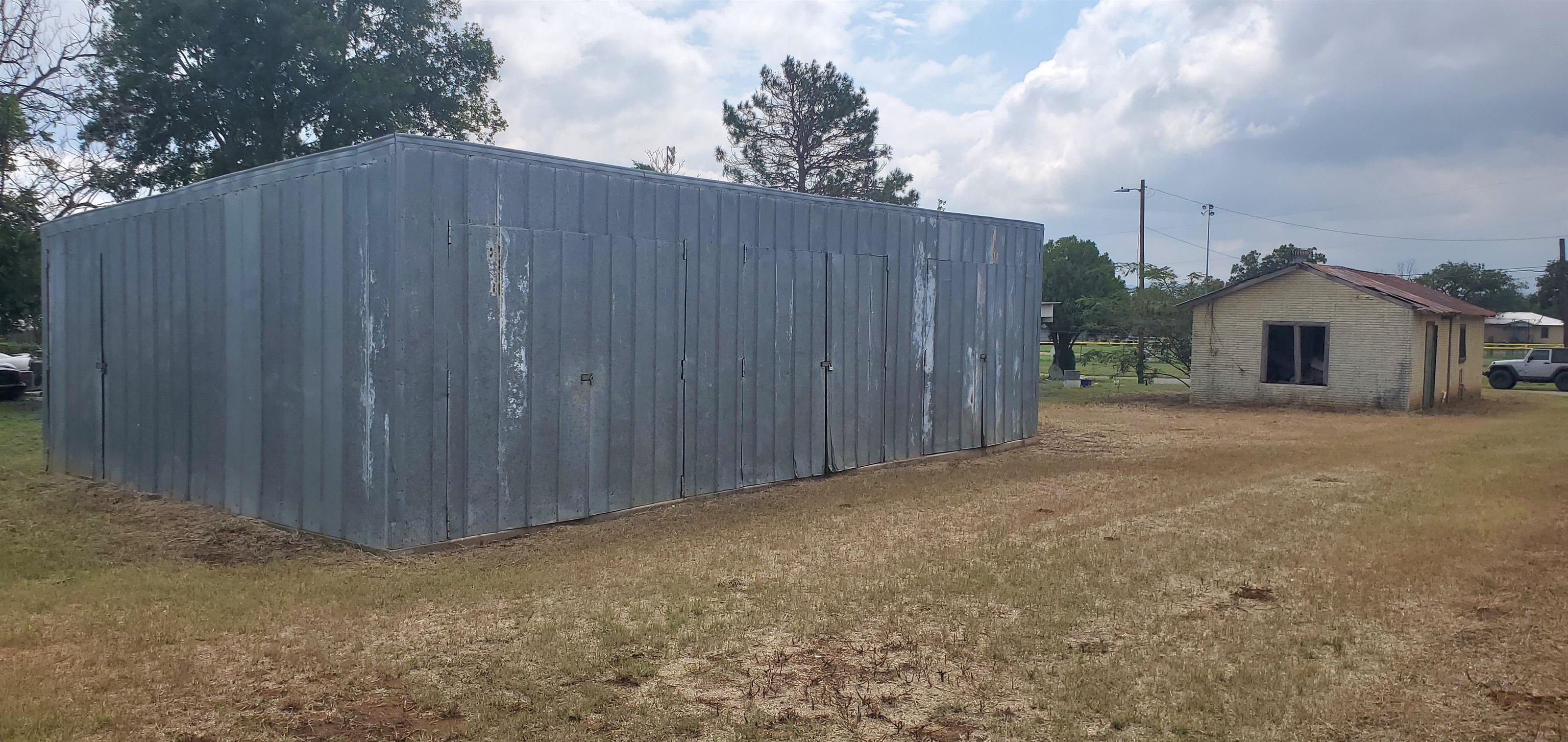 a view of a house with wooden fence