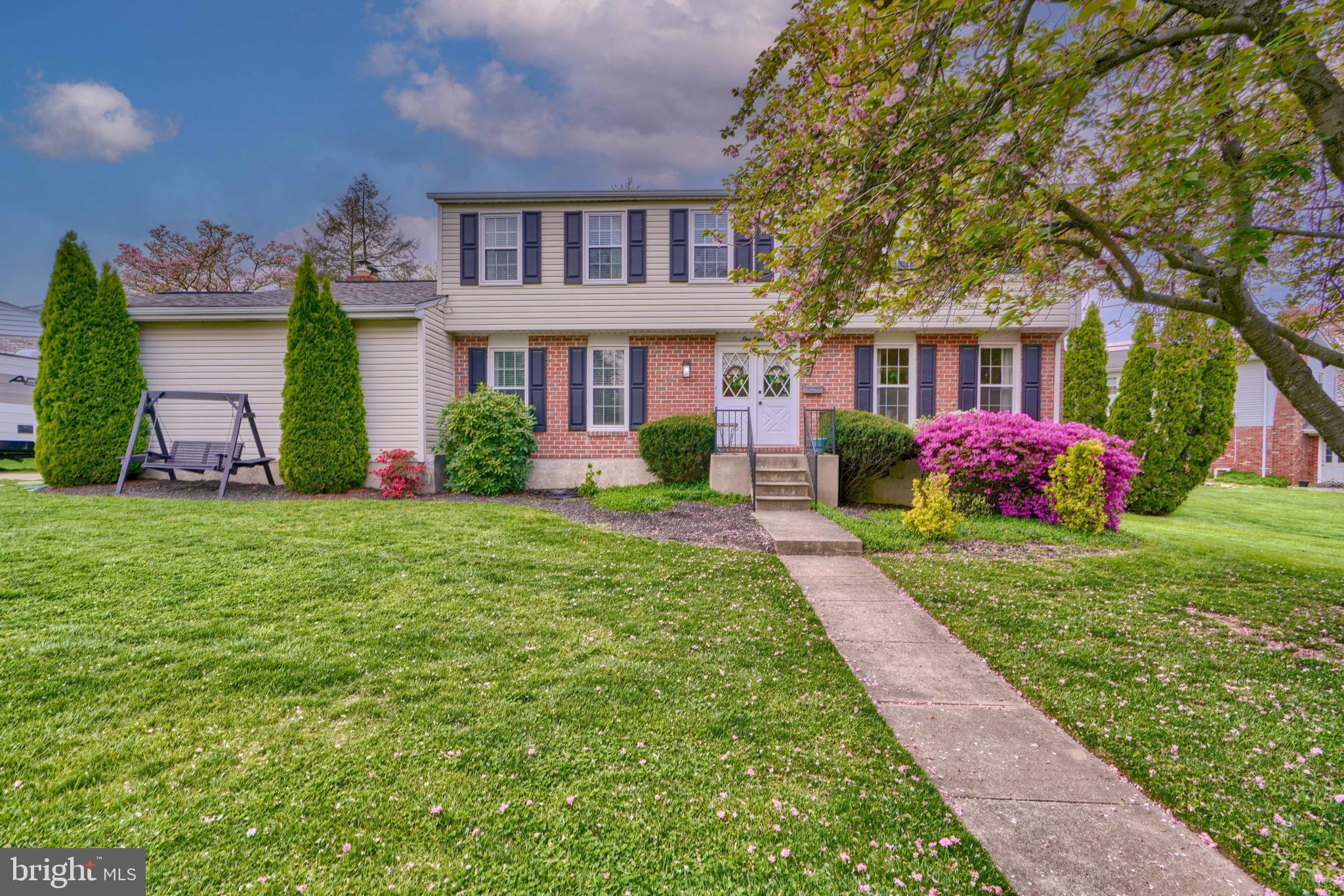 a front view of house with yard and green space