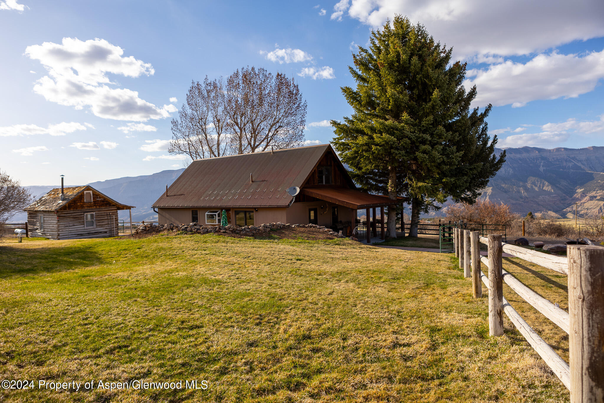 a view of a house with a yard and tree s