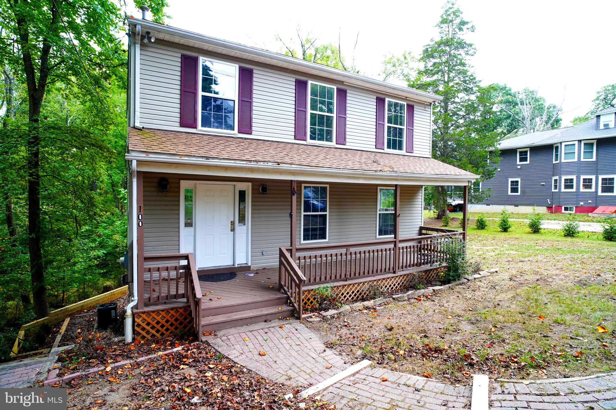 a view of a house with a yard and sitting area