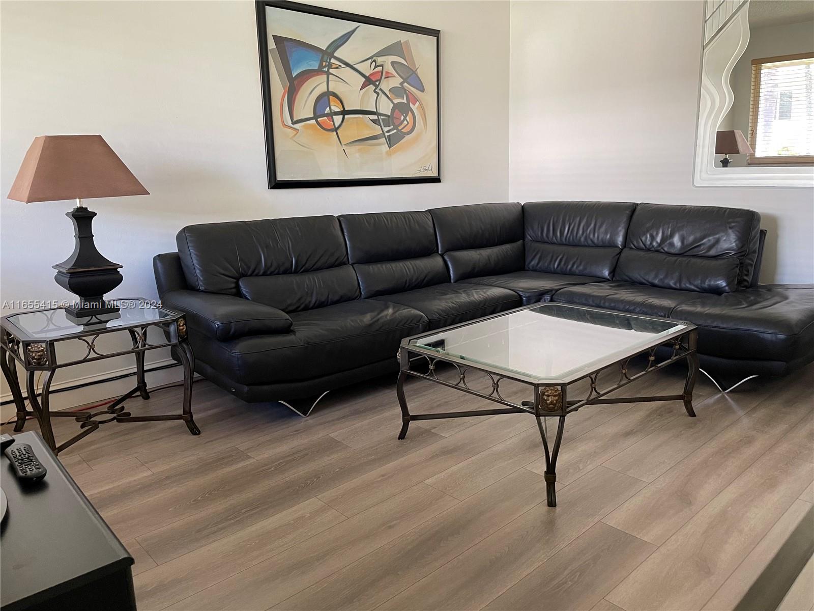 a living room with furniture a rug and a lamp