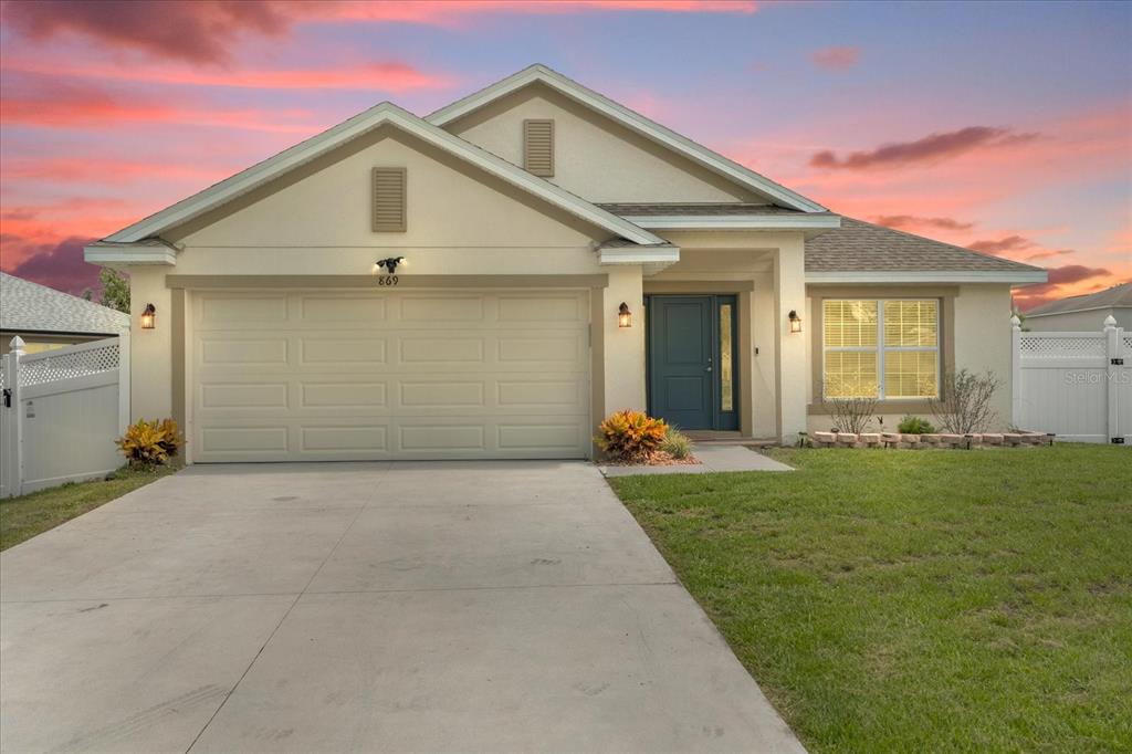 a view of a yard in front view of a house