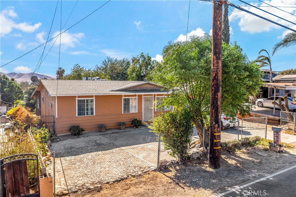 a view of a house with a tree in the background