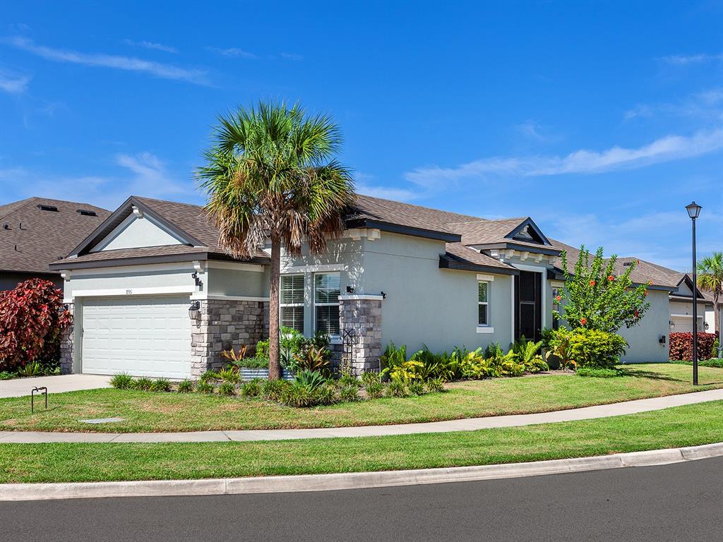 a front view of a house with a garden