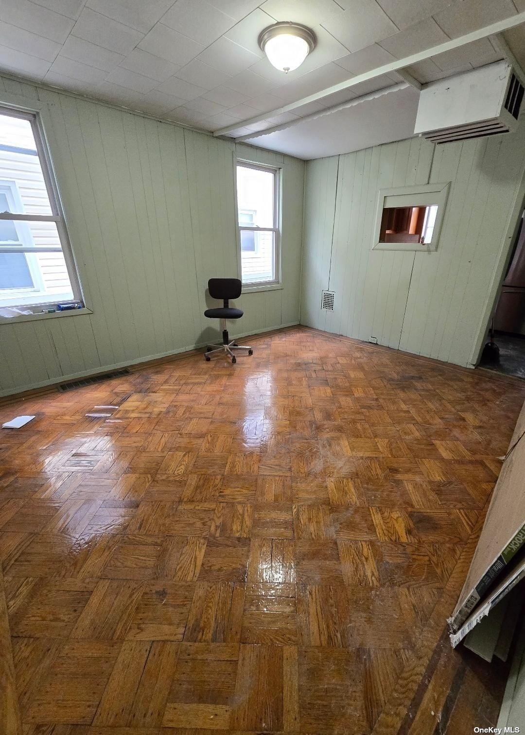 a view of a livingroom with an empty space and windows