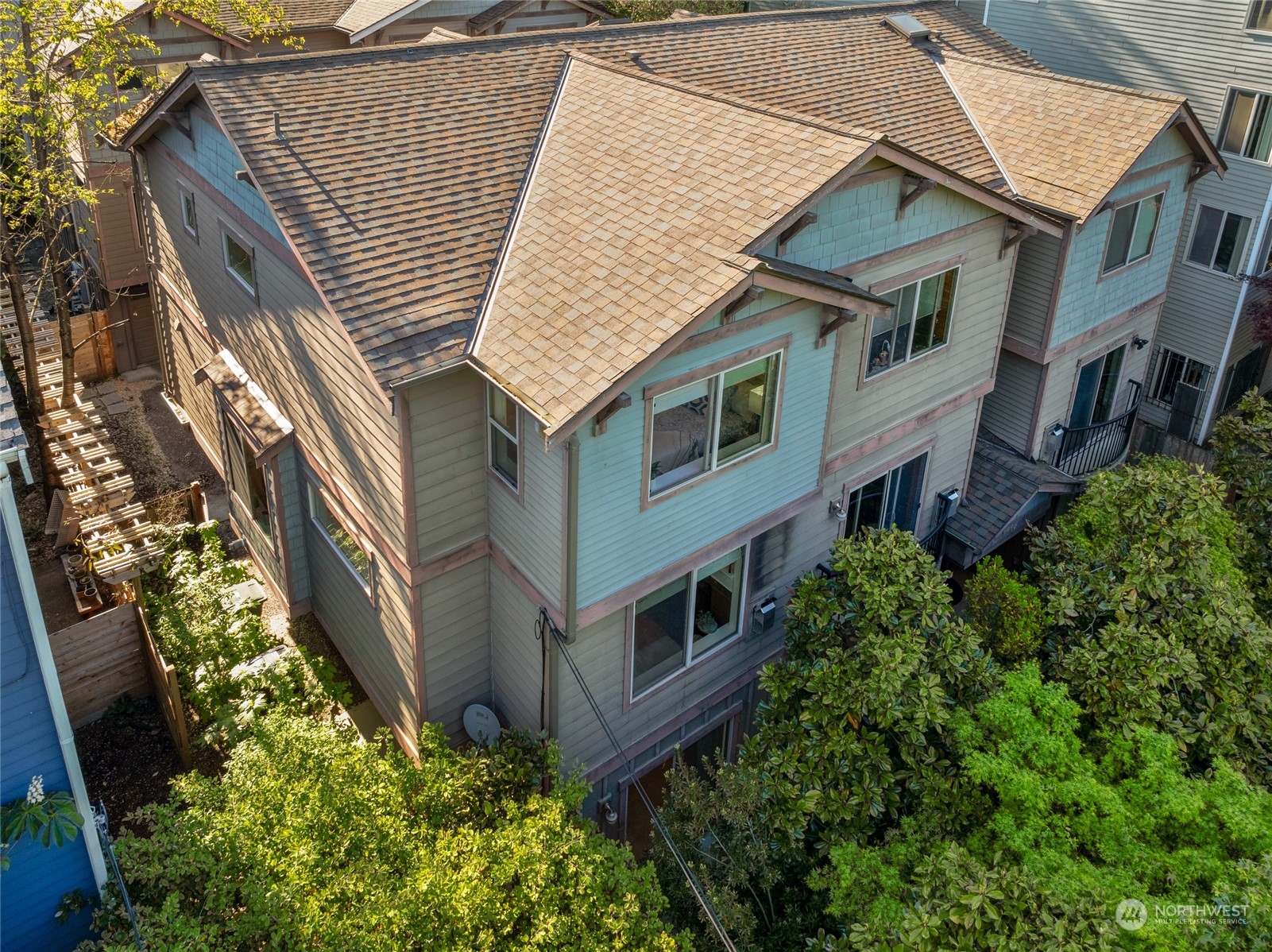 an aerial view of a house with balcony and trees