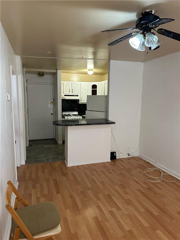 a view of kitchen with stainless steel appliances kitchen island sink stove and refrigerator